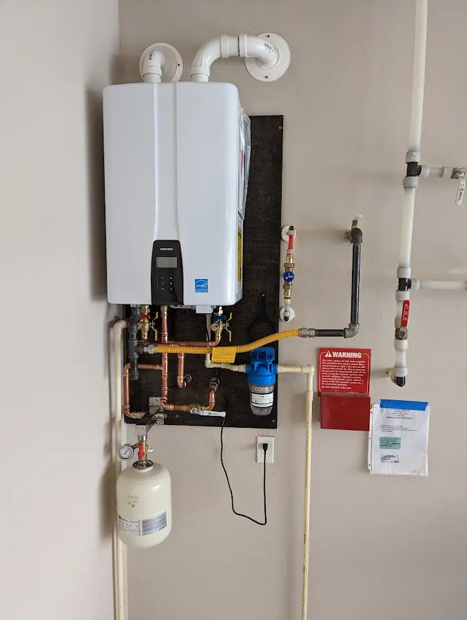 Professional plumber installing copper piping in a Mechanicville home